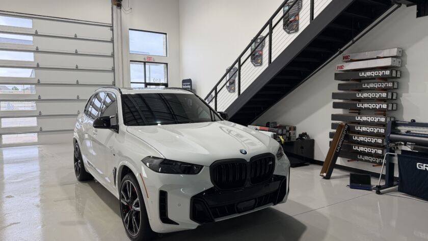 Professional auto window tinting on a BMW X5 at Kingdom Window Tint in Lewisville, TX