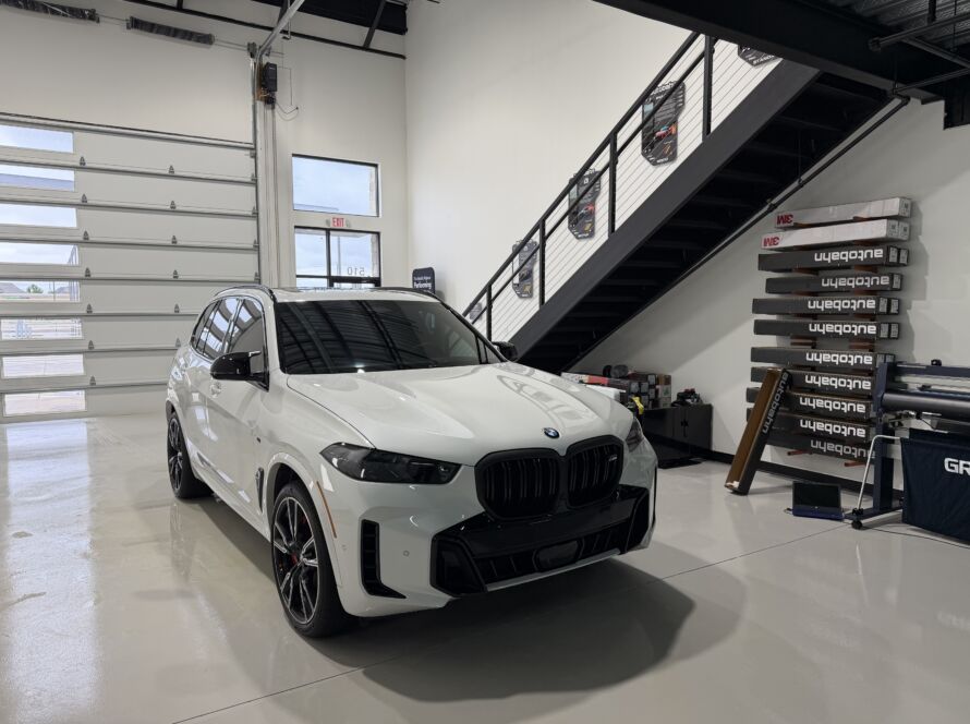 Professional auto window tinting on a BMW X5 at Kingdom Window Tint in Lewisville, TX