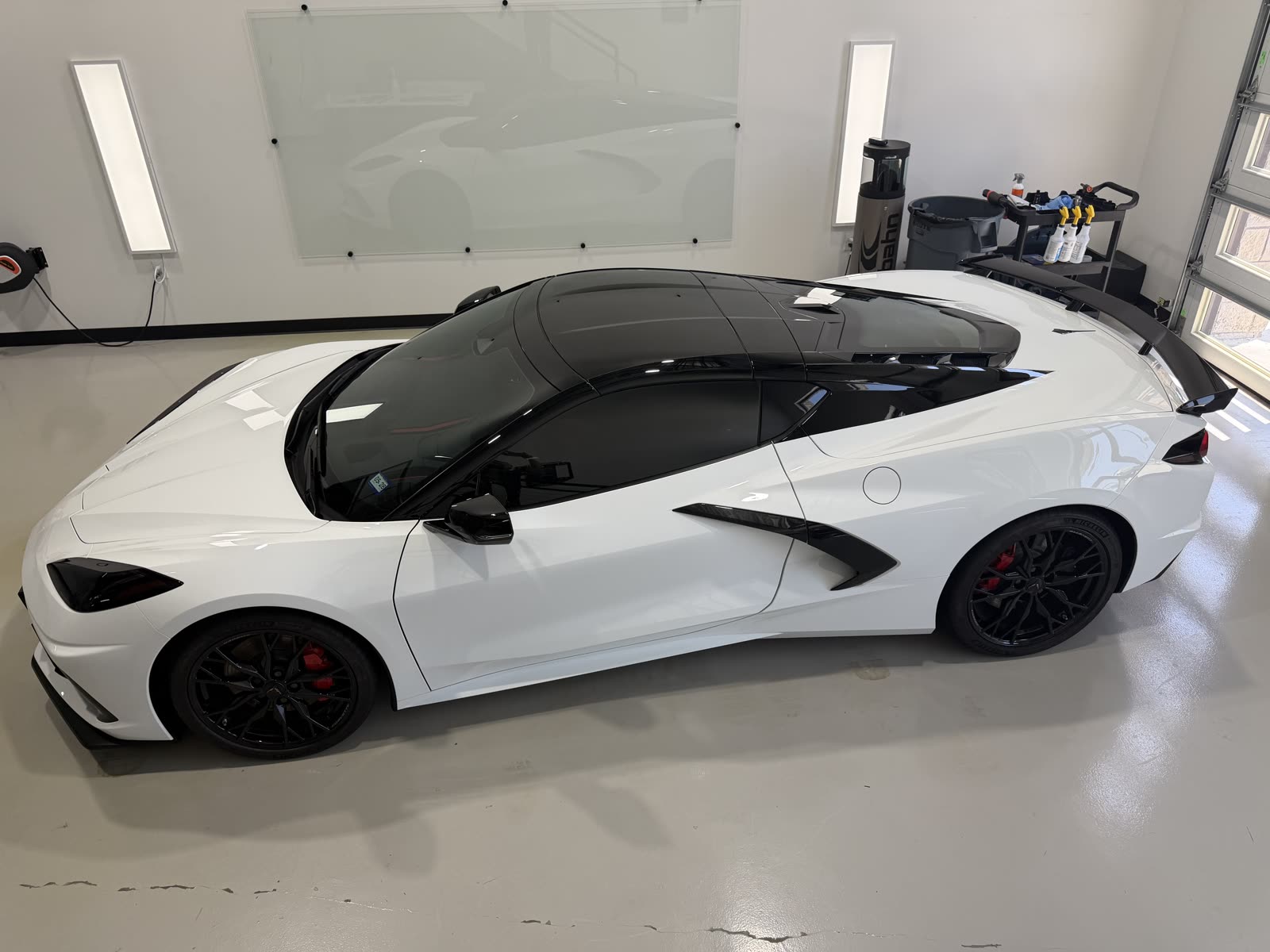 Side profile of a white C8 Corvette with PPF, ceramic coating, i3+ tint and roof blackout in Lewisville