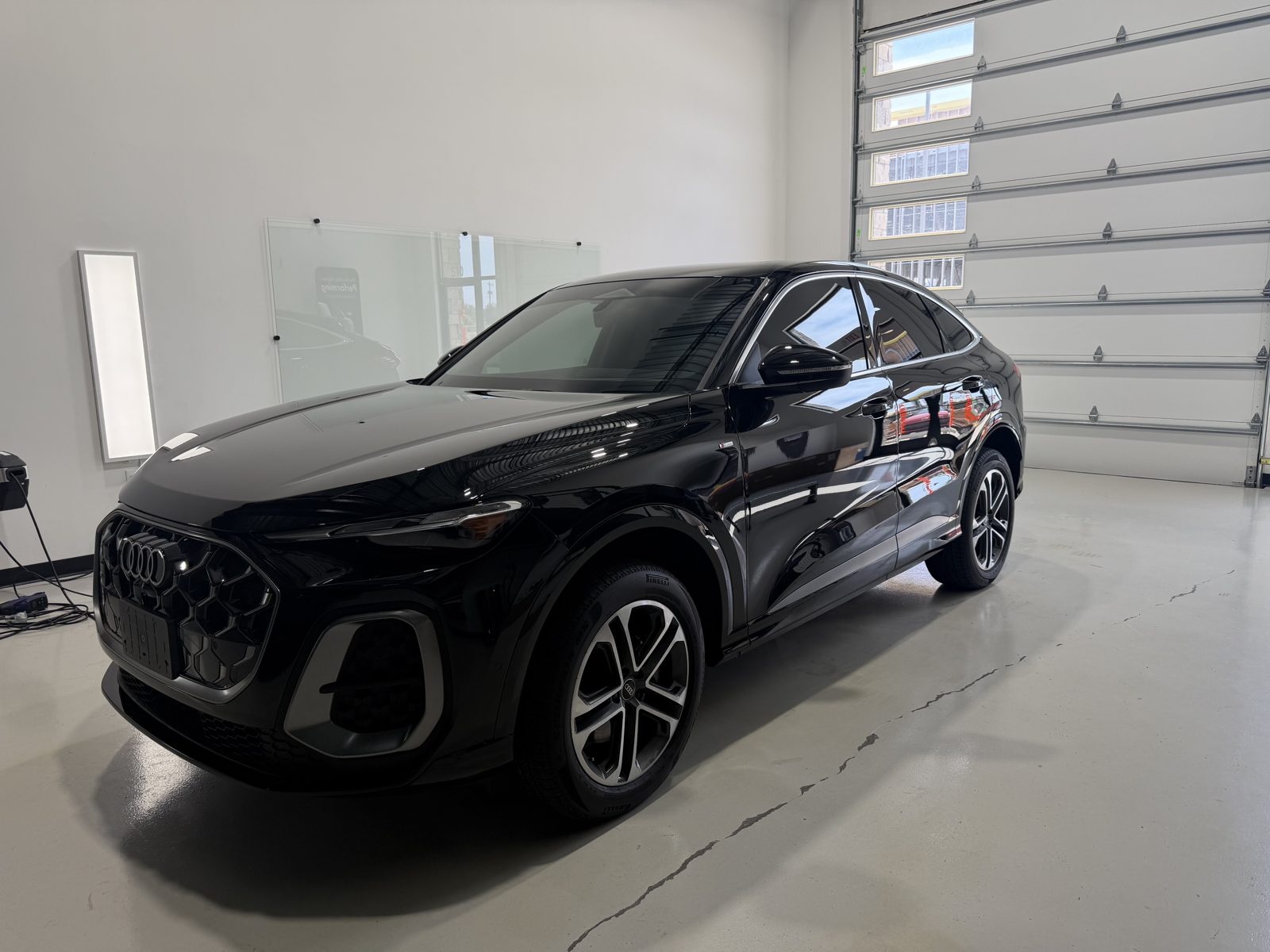 Front of a black Audi Q5 Sportback after paint correction and ceramic coating