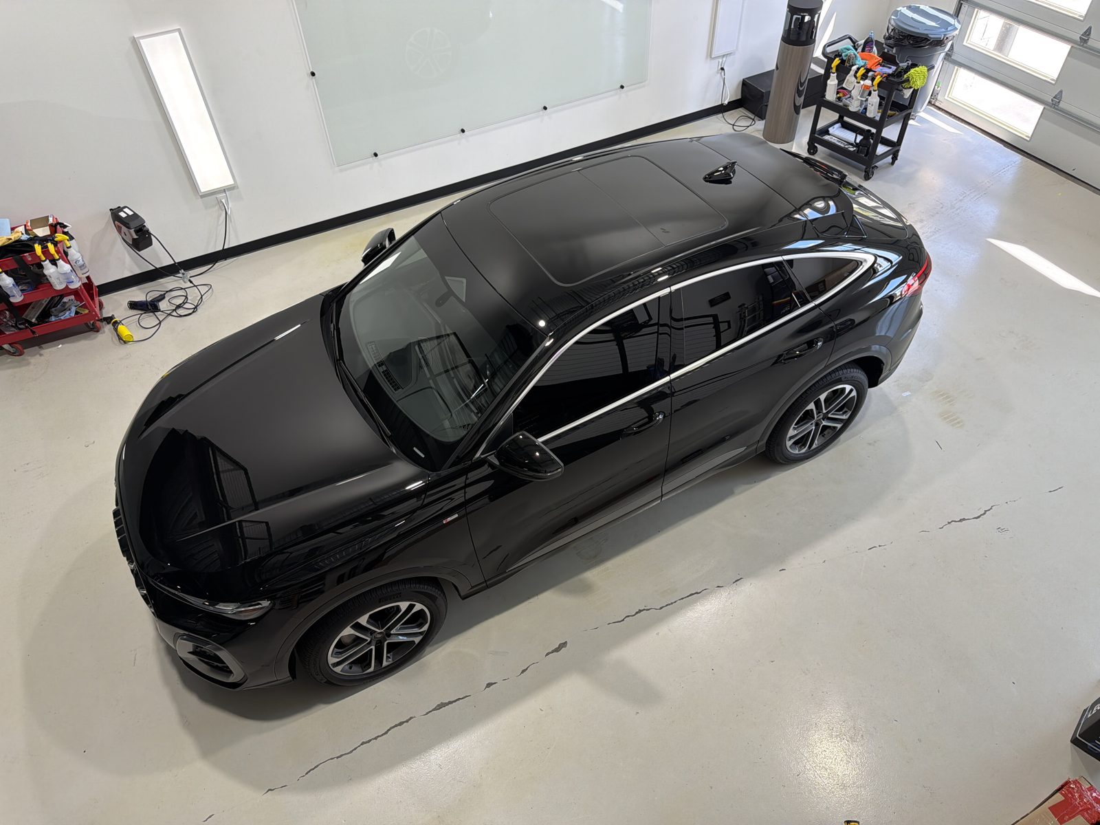 Overhead view of a ceramic coated black Audi Q5 Sportback in the Kingdom Window Tint shop
