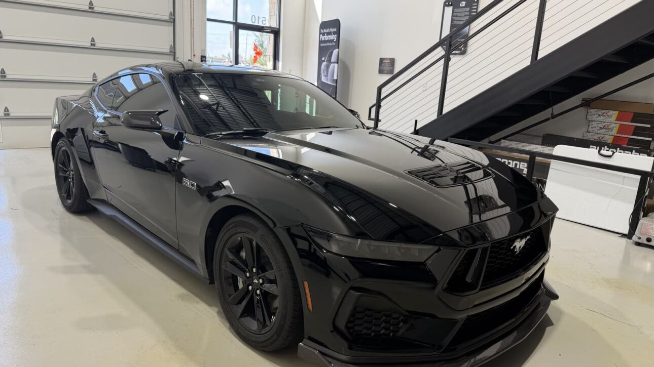 Black Ford Mustang GT after paint correction and ceramic coating at Kingdom Window Tint in Lewisville, TX