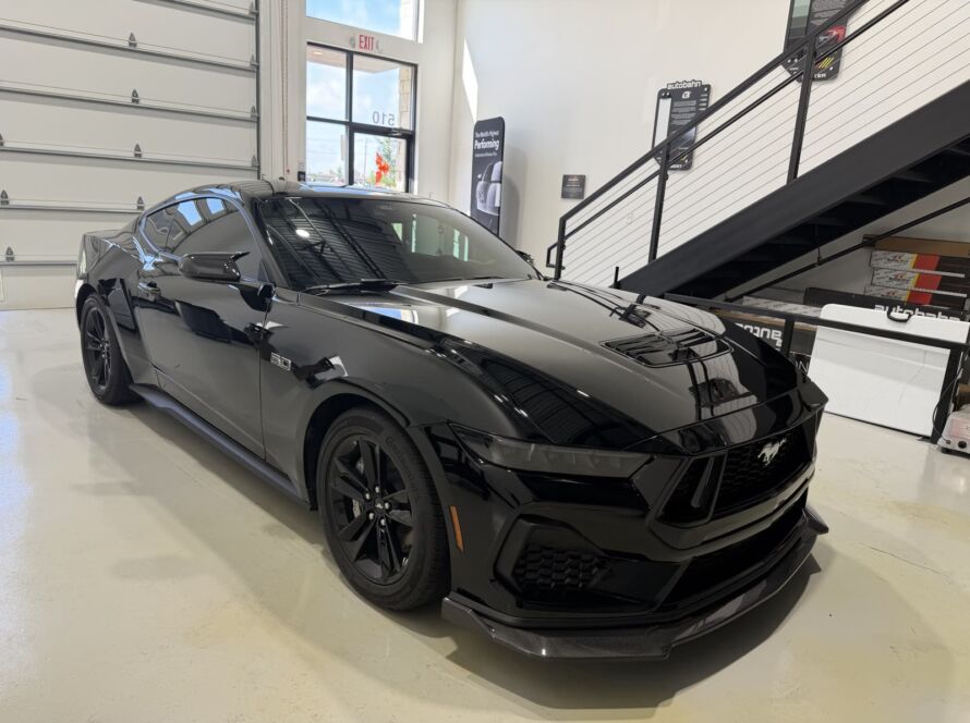 Black Ford Mustang GT after paint correction and ceramic coating at Kingdom Window Tint in Lewisville, TX