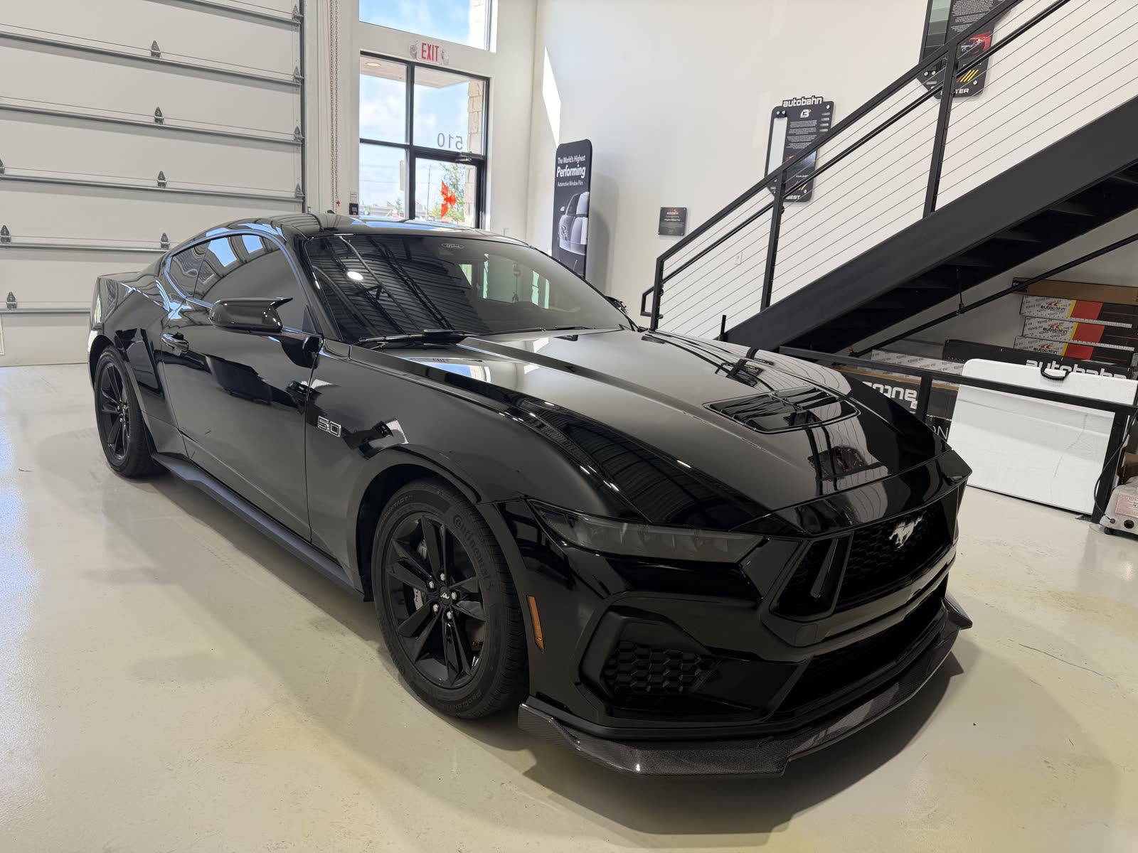 Black Ford Mustang GT after paint correction and ceramic coating at Kingdom Window Tint in Lewisville, TX