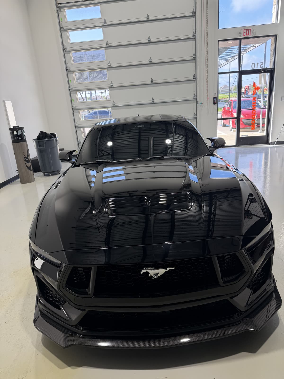 Front and hood of a black Ford Mustang GT after two-step paint correction and ceramic coating