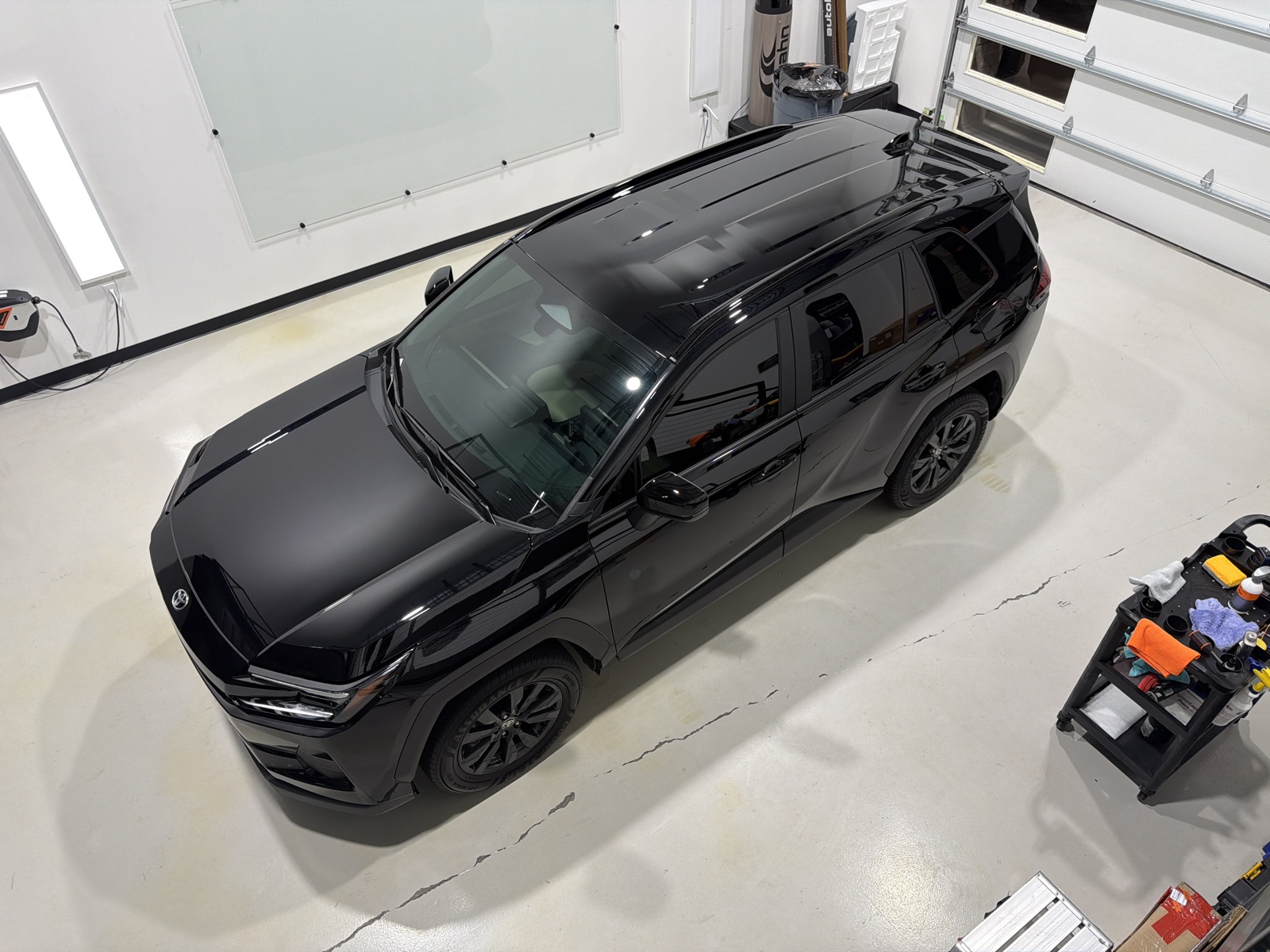 Overhead view of the hood and roof of a ceramic coated black Toyota RAV4