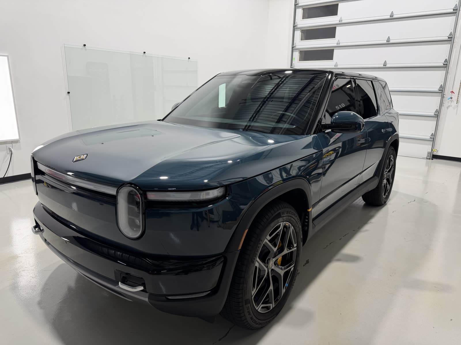 Gloss on the hood and front fender of a Rivian R1S with ceramic coating over PPF